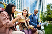 Office workers eating lunch together