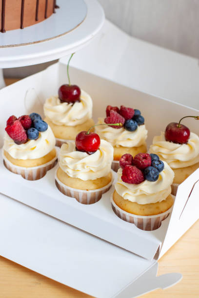 istock Close up on a set of cupcakes decorated with pecan nuts and maple syrup on gift box 1477533414
