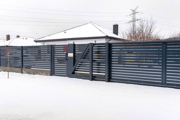 istock Modern panel fence in anthracite color, visible sliding gate and wicket with letterbox in winter. 1477534710