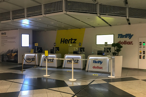 Temporarily closed Hertz car rental office. Hertz car rental company that have rental offices located in various airports around the world, and while their specific policies may vary, both offices generally offer rental services to customers during airport operating hours.