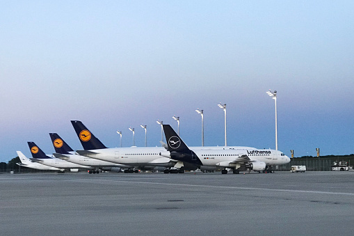 Lufthansa planes parked side by side at Munich Airport at night is a common sight due to the airline's large presence at the airport and the practice of parking unused planes in designated aprons to conserve fuel and reduce noise pollution