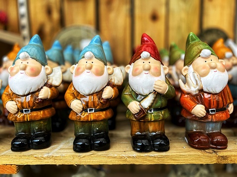 A retail display of garden gnomes for sale in the garden store. Selective focus with room for copy space.