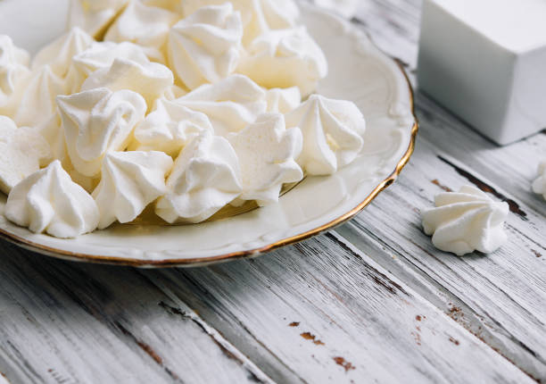 istock Meringue cookies in in a plate on wood 1477535986