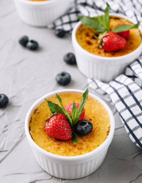 istock cup of creme brulee with dessert plug and mint leave with berries 1477537027