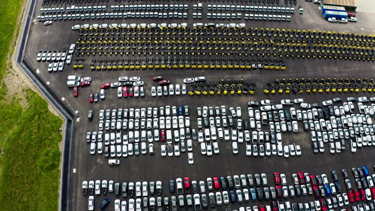 Aerial view of a huge car distribution lot with different car and truck brands