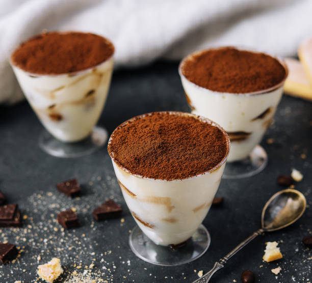 Italian dessert tiramisu in glass and eclairs with chocolate slices Italian dessert tiramisu in glass and eclairs with chocolate slices tiramisu glass stock pictures, royalty-free photos & images