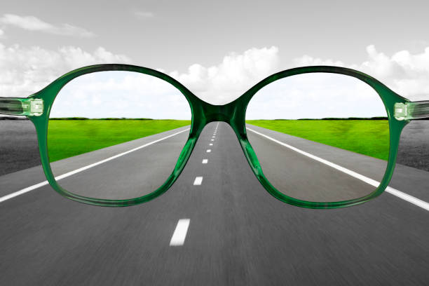 istock Green reading glasses against blurred street background 1477539866