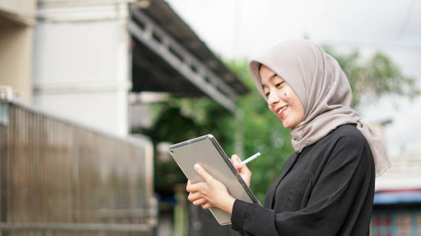 istock young hijab women using tablet in outdoor 1477540183