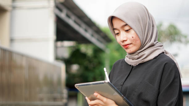 istock young hijab women using tablet in outdoor 1477540193
