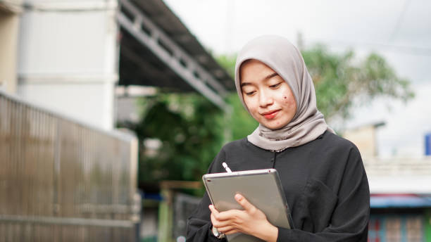 istock young hijab women using tablet in outdoor 1477540416