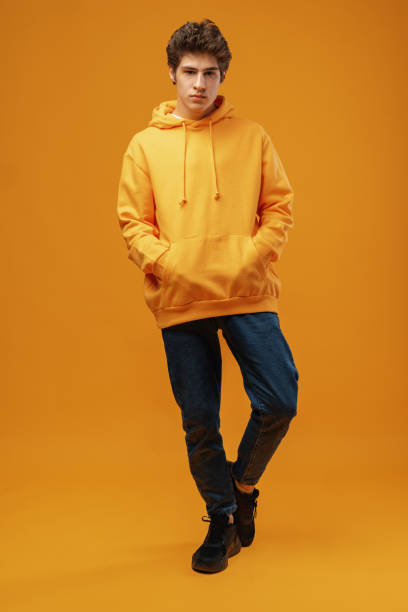 istock Full body image of young man posing on yellow background 1477543232
