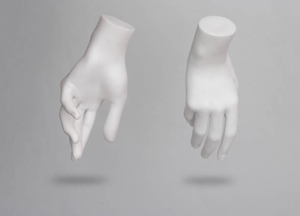 White mannequin hands levitating on gray background with shadow stock photo