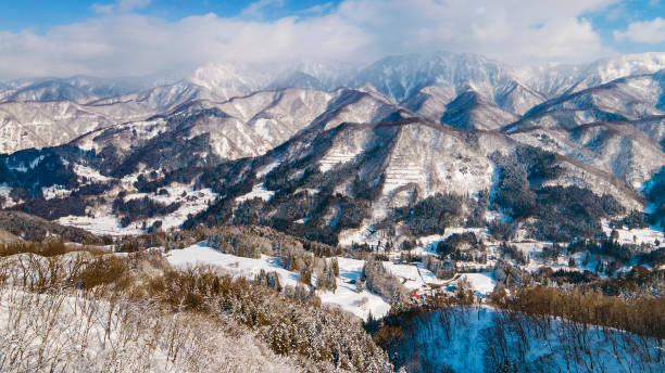 Snowed mountain ridge and village on the valley.