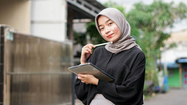 istock young hijab women using tablet in outdoor 1477545386