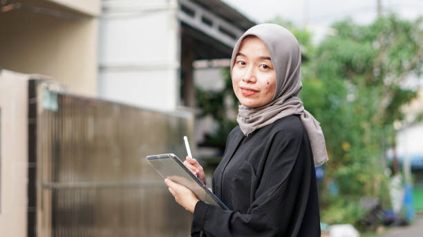istock young hijab women using tablet in outdoor 1477545393