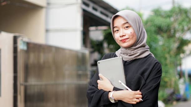 istock young hijab women using tablet in outdoor 1477545400