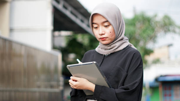 istock young hijab women using tablet in outdoor 1477545914