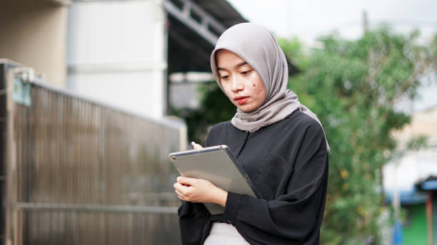 istock young hijab women using tablet in outdoor 1477545951
