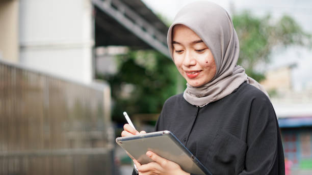 istock young hijab women using tablet in outdoor 1477547182