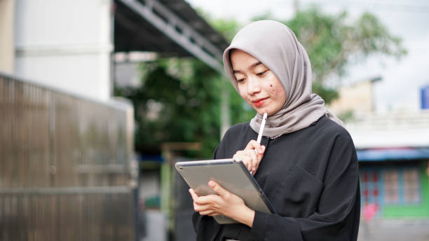 istock young hijab women using tablet in outdoor 1477547197