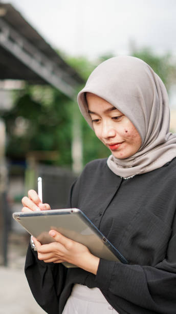 istock young hijab women using tablet in outdoor 1477547281