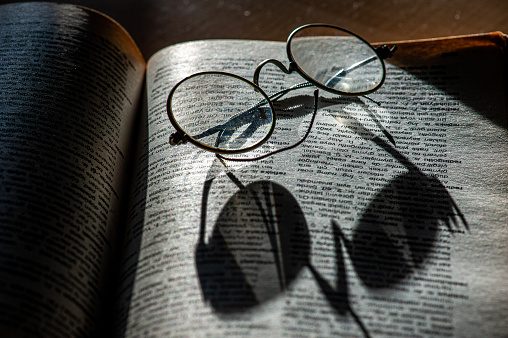 Reading glasses and their shadow on Turkish dictionary