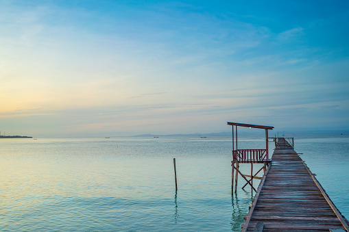 Pier in morning time at the coastline of the village of Saporkren Waisai, Raja Ampat, blue sky