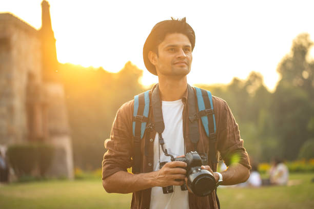 istock Thoughtful man with camera at historic site during vacation 1477552018
