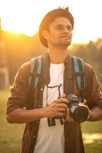 istock Thoughtful man with camera at historic site during vacation 1477552081