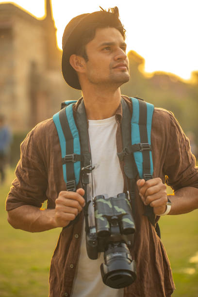 istock Thoughtful man with camera at historic site during vacation 1477552163