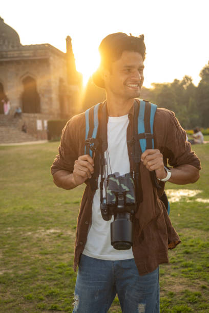 istock Happy man with camera at historic site during vacation 1477552275