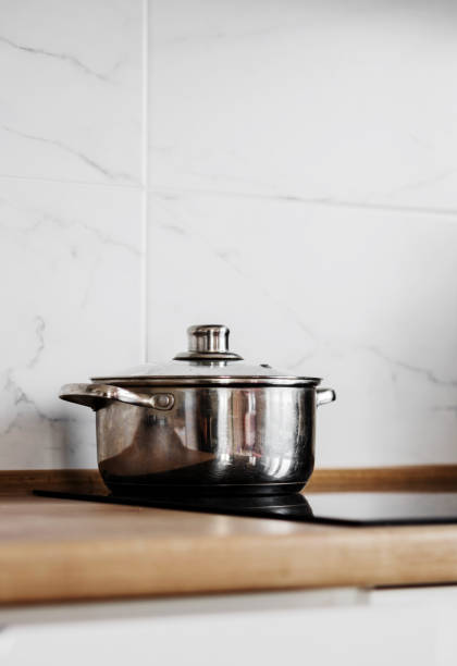 istock Metal pot on induction cooker. k 1477552655