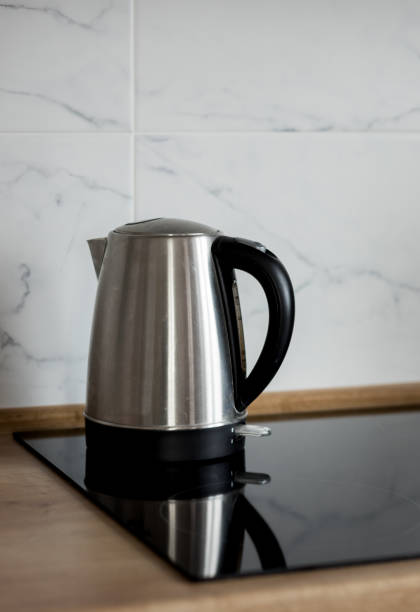 istock electric kettle on the stove kitchen. 1477552668