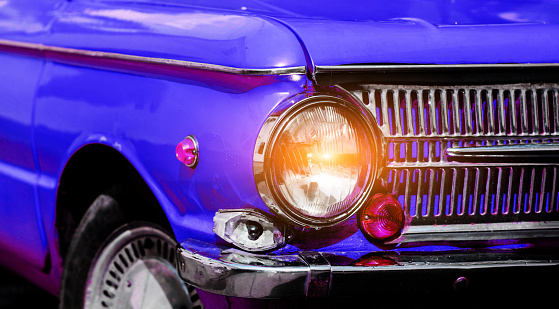 Classic Retro Car. front headlight of the vintage retro blue automobile
