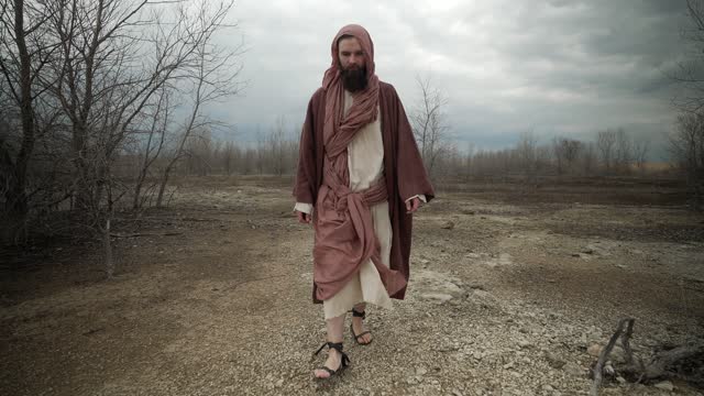 Man Dressed As Jesus Christ, Biblical Prophet Walking In Wasteland