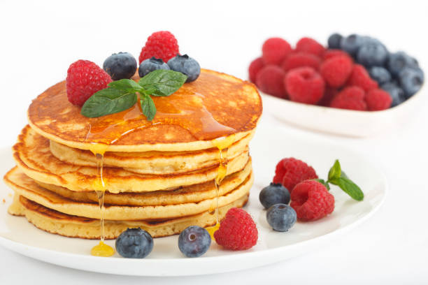 American pancakes with fresh blueberry, raspberry and honey stock photo