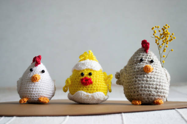 istock Easter Crochet chickens and chicken with mimosa on light background. 1477555087