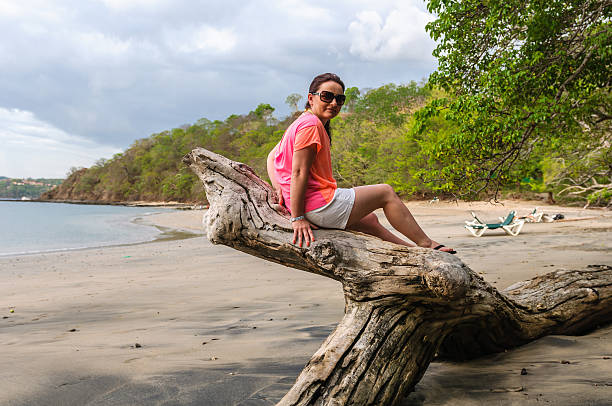 istock woman sitting on a stump 147755652