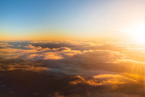 istock Flying above the clouds in golden light 1477559705