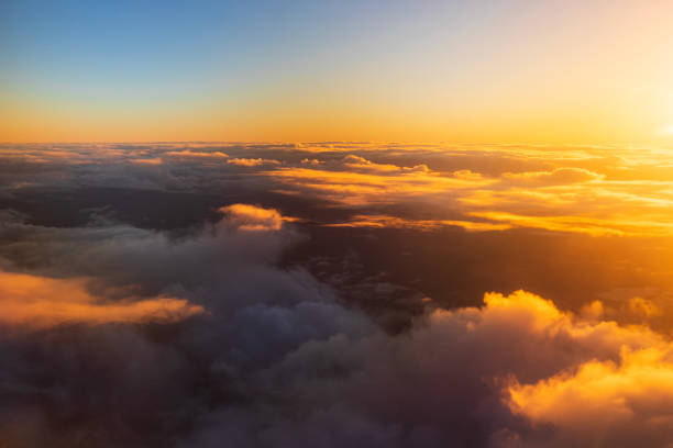 istock Flying above the clouds in golden light 1477559713