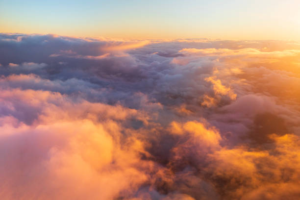 istock Flying above the clouds in golden light 1477559724