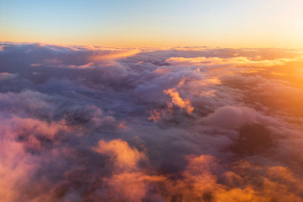 istock Flying above the clouds in golden light 1477559755