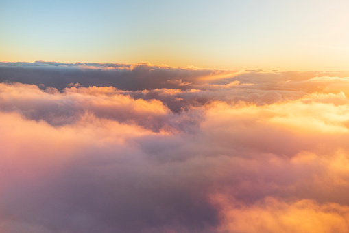 Flying above the clouds in golden light.