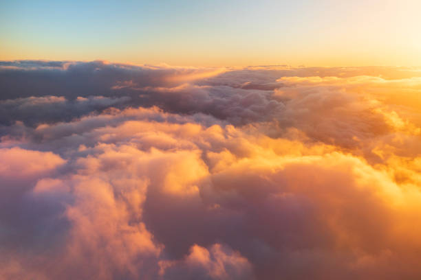 istock Flying above the clouds in golden light 1477559785