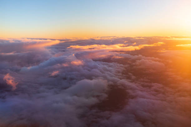 istock Flying above the clouds in golden light 1477559791