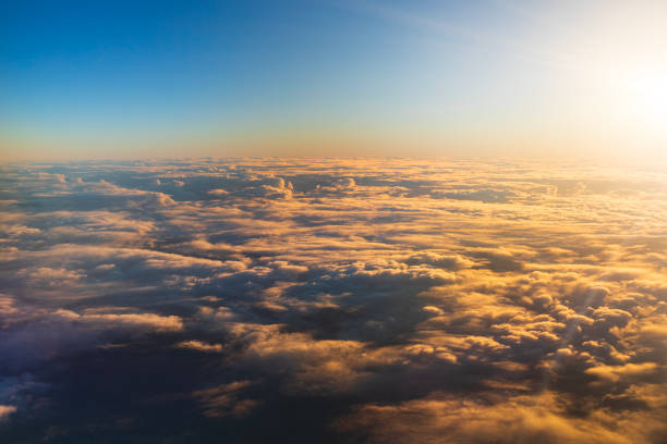 istock Flying above the clouds in golden light 1477559802