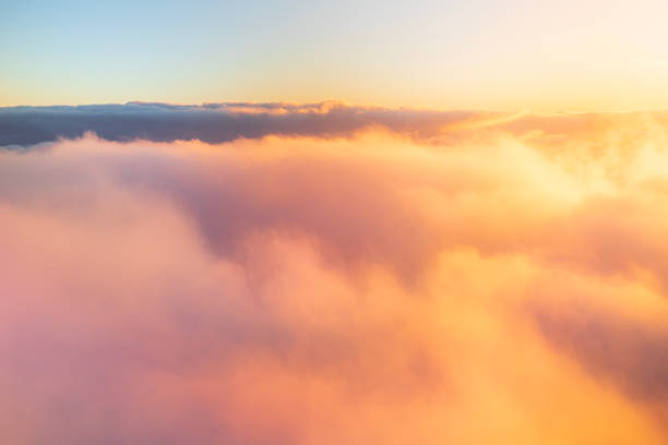 istock Flying above the clouds in golden light 1477559808