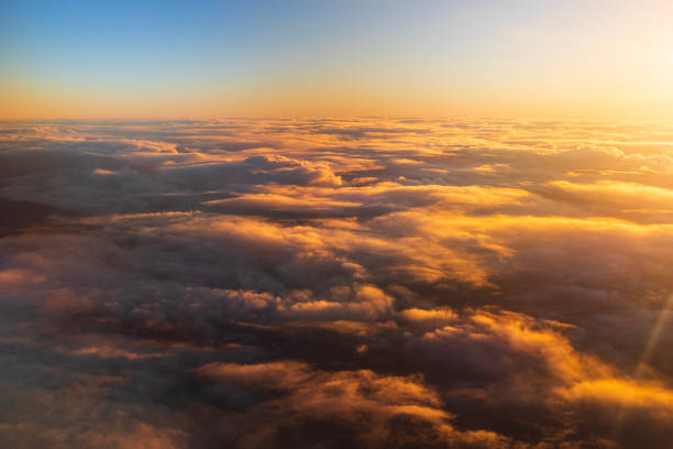 istock Flying above the clouds in golden light 1477559816