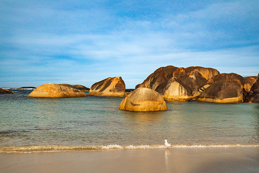 Empty white sand beach with large boulder rocks, Western Australia scenery.
