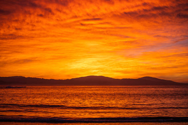 Bright red cloudscape at sunrise over the ocean